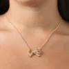 Pava-halsband med rosett och örhängen