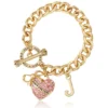 Rosa Pava-hjärta med toggle-lås som armband